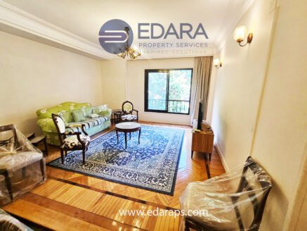 Classic living room with green sofa and wooden chairs – Edara Property Services