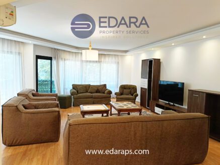 Spacious living room with modern brown sofas and wooden flooring – Edara Property Services